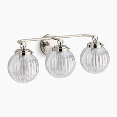 three light bathroom fixture with chrome finish and clear glass globes on the sides,