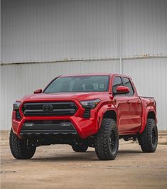 a red truck parked in front of a building