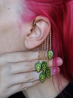 Embrace the beauty of nature with our delicate leafy ear cuff  This golden wonder, adorned with charming green leaves that gently sway, will add a touch of elegance and whimsy to your look. Slip it on and let your style flourish! My video instruction on HOW to wear my ear cuff (Insta Reel Video) https://bit.ly/3QkUp4Y See more of my ear cuffs and earrings - https://etsy.me/3SxnsEo If you want a custom request shoot us a message. We can make these crystal crowns and combs with any of the crystals Cool Ear Cuffs, Nature Ear Rings, D&d Jewelry, Ear Cuff Ideas, Fairy Inspired Jewelry, Unique Dangle Cartilage Earrings, Green Fairytale Accessories, Polymer Clay Ear Cuff, Fantasy Style Single Earring For Festival