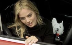 a woman sitting in the passenger seat of a car