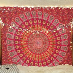 a bed with a red and gold tapestry on it