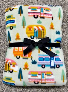 an image of a baby blanket with rv and camper print on it, sitting on the floor