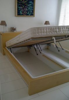 a bed that is sitting in the middle of a room with no sheets on it