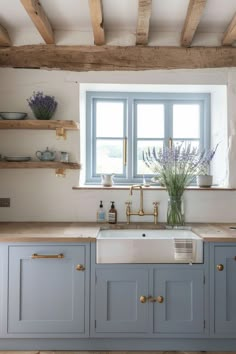 a kitchen with blue cabinets and white walls