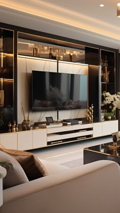 a living room filled with furniture and a flat screen tv mounted to the side of a wall