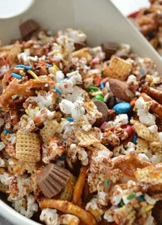 a white bowl filled with cereal and marshmallows on top of a table