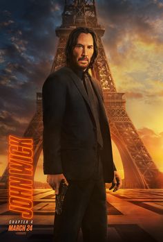 a man in a suit standing next to the eiffel tower