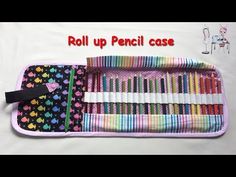 an open case filled with lots of different colored crayon pencils on top of a white sheet