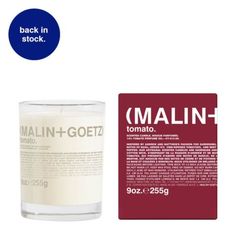 an image of a candle that is in front of a sticker with the word mailin - gotz on it