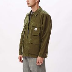 The Peace BDU (Battle Dress Uniform) jacket is constructed of 100% organic cotton and features a vintage look, full-zip closure with snap placket closure, four button closure pockets at front and a woven logo label sewn at chest. 100% organic cotton. Machine wash cold. Imported. By OBEY.Style: 121800440 Cotton Utility Jacket With Pockets And Long Sleeves, Long Sleeve Cotton Utility Jacket With Pockets, Long-sleeved Cotton Utility Jacket For Outdoor, Green Cotton Outerwear With Patch Pockets, Button-up Streetwear Outerwear With Multiple Pockets, Button-up Outerwear With Multiple Pockets For Streetwear, Cotton Utility Jacket With Long Sleeves For Streetwear, Cotton Long-sleeved Utility Jacket For Streetwear, Outdoor Cotton Utility Jacket With Pockets