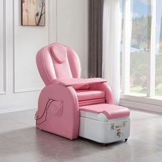 a pink and white reclining chair sitting on top of a hard wood floor next to a window