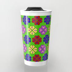 a green cup with colorful flowers on it