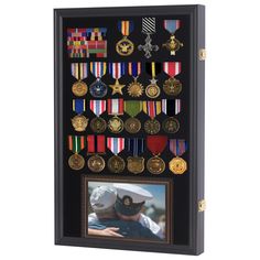 an award plaque with medals on it and a photo frame in the middle that is mounted to