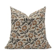 a decorative pillow with an orange and black flower pattern on the front, sitting on a white background