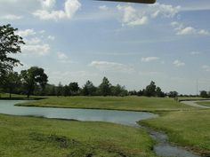 a small pond in the middle of a golf course