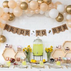 a table topped with lots of balloons and plates