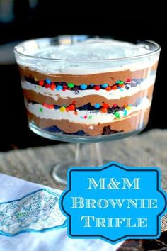 a brownie trifle with white frosting and sprinkles