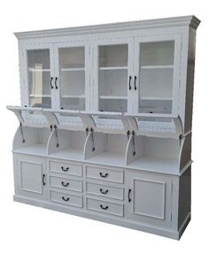 a white china cabinet with glass doors and drawers