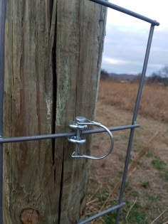 a wooden post with metal bars attached to it