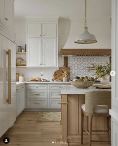 the kitchen is clean and ready for us to use it's white cabinetry