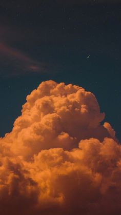 an orange cloud with the moon in the sky