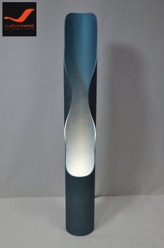 a tall blue vase sitting on top of a white table