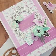 a close up of a greeting card on a table with scissors and other crafting supplies