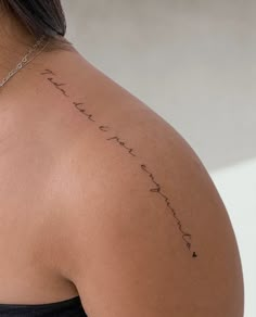 the back of a woman's shoulder with writing on it