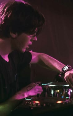 a young man is playing music on his turntable