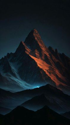 the top of a mountain is lit up at night with red light coming from it