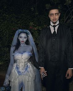 a man and woman dressed up as corpse from corpse brides are standing next to each other