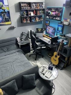 a living room filled with furniture and lots of shelves on the wall next to a guitar