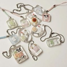 a bunch of key chains that have various items on them, all in different shapes and sizes