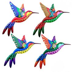 three colorful hummingbirds flying in the air