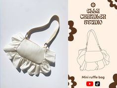 a small purse with ruffles on the front and side, sitting next to an instruction manual