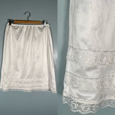 Dainty 80s white lace slip skirt! This skirt has the prettiest lace trim on the bottom & is quite see through.  Size Small - Large Brand - Patricia Era - 80s Excellent Vintage Condition (FLAW - one tiny spot at the wait of the skirt - see last photo) Made in Canada Measurements LAYING FLAT Waist - 12.5" - 20" (Stretchy waistband) Hips - 23"  Length - 25" Please let me know if you have any questions! Fitted Summer Skirt With Delicate Lace, Summer Fitted Skirt With Delicate Lace, Fitted Delicate Lace Skirt For Summer, Vintage White Lace Bottoms, White Vintage Lace Bottoms, White Lace Vintage Bottoms, Vintage Lace Trim Bottoms For Summer, Vintage Bottoms With Lace Trim For Summer, Vintage Lace Trim Petticoat For Summer