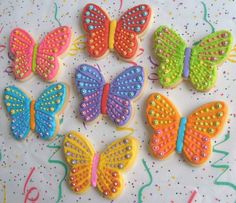 decorated cookies in the shape of butterflies on a table