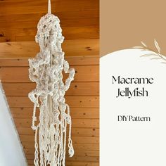 a white crocheted chandelier hanging from a ceiling in front of a wood paneled wall