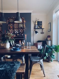 a dining room table with chairs and lights