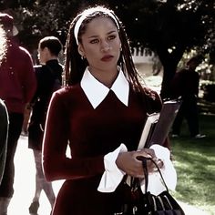 a woman in a red dress holding a book