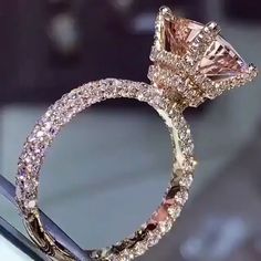 an engagement ring with pink and white diamonds on display at a jewelery showroom