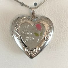 Necklace Sterling Silver "I Love You" Heart $100 Sterling Silver "I Love You" Heart Locket Msrp $100.00 Show How Much You Care When You Gift This Floral-Accented Heart Locket. Comes In A Gift Box. Locket Details: Brand Treasured Moments New In Box Locket Length: 1 In. Necklace Length: 18 In. Clasp: Spring-Ring Metal: Sterling Silver Photo Slots: 2 Inscription: "I Love You" Features: Pink & Green Rose Accent, Scroll Details Fine Jewelry Silver Heart Locket Necklace, Pretty Lockets, Rose Locket Necklace, Vintage Sterling Silver Heart Locket Necklace, Pink Locket, Heart Locket Necklace Silver, Vintage Sterling Silver Heart Pendant Locket Necklace, Vintage Silver Locket Necklace For Valentine’s Day, Locket Necklace Vintage