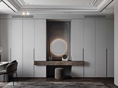 an elegant dressing room with white cupboards and marble counter tops, along with a round mirror on the wall