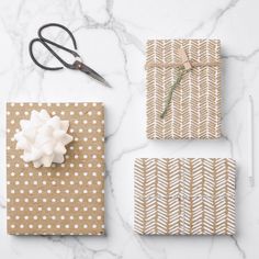 wrapping presents with white polka dots on brown paper, scissors and twine string tied to them