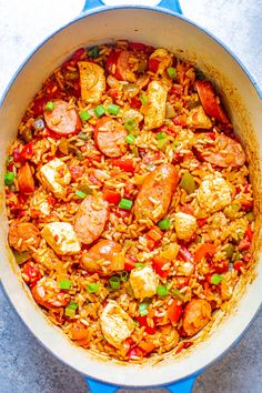 a blue pot filled with rice and sausage