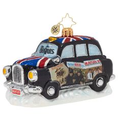 an ornament shaped like a taxi with the british flag on top