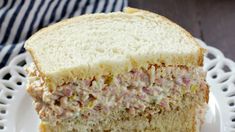 a close up of a sandwich on a plate with a fork and napkin in the background