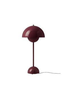 a red table lamp on a white background