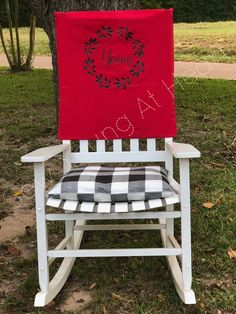 a white rocking chair with a red banner on it