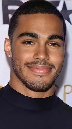 a close up of a person with a goatee and beard smiling at the camera